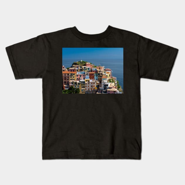 View on the cliff town of Manarola, one of the colorful Cinque Terre on the Italian west coast Kids T-Shirt by Dolfilms